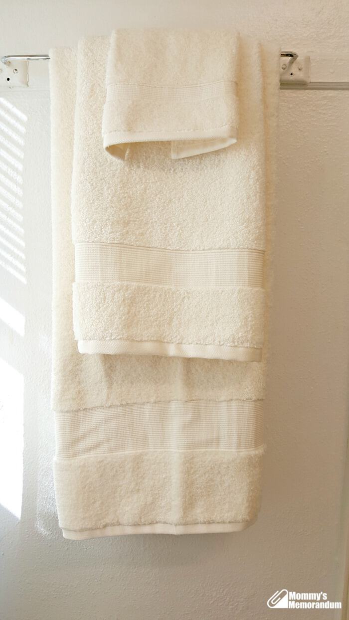 's hotel collection microcotton towel hanging on towel rack
