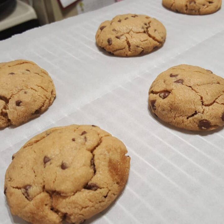 These Peanut Butter Chocolate Chip cookies out of the oven, warm--they are my guilty pleasure. More of a chocolate chip cookie texture than peanut butter cookies; these cookies are the best of both worlds.
