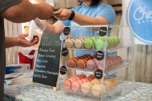 smart consumer buying macarons from french pastry shop