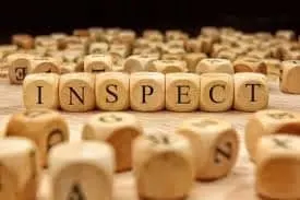 inspect spelled out in wooden beads