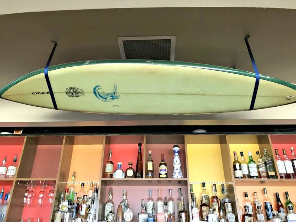 santa cruz jack oneill lounge surfboard over bar