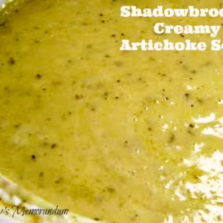 Close-up of creamy Shadowbrook Artichoke Soup with herbs