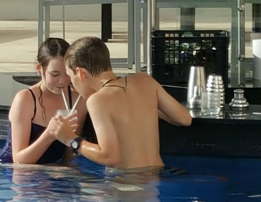 sharing a pina colada at a swim up bar at Nickelodeon resort