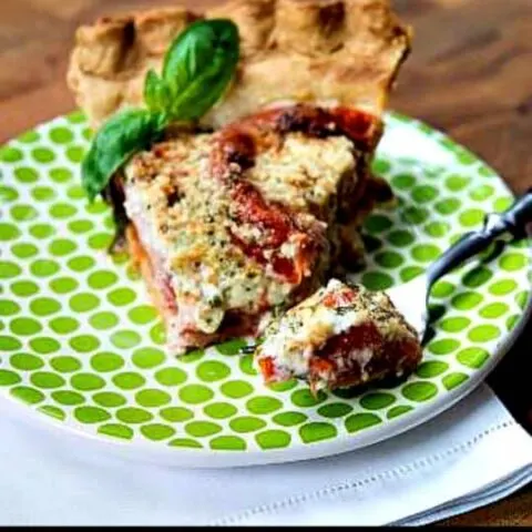 Delicious homemade tomato pie with a flaky crust, fresh tomatoes, and basil, ideal for summer meals.