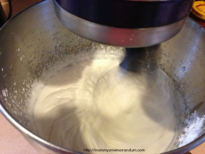 Stand mixer whipping cream to make homemade whipped cream.